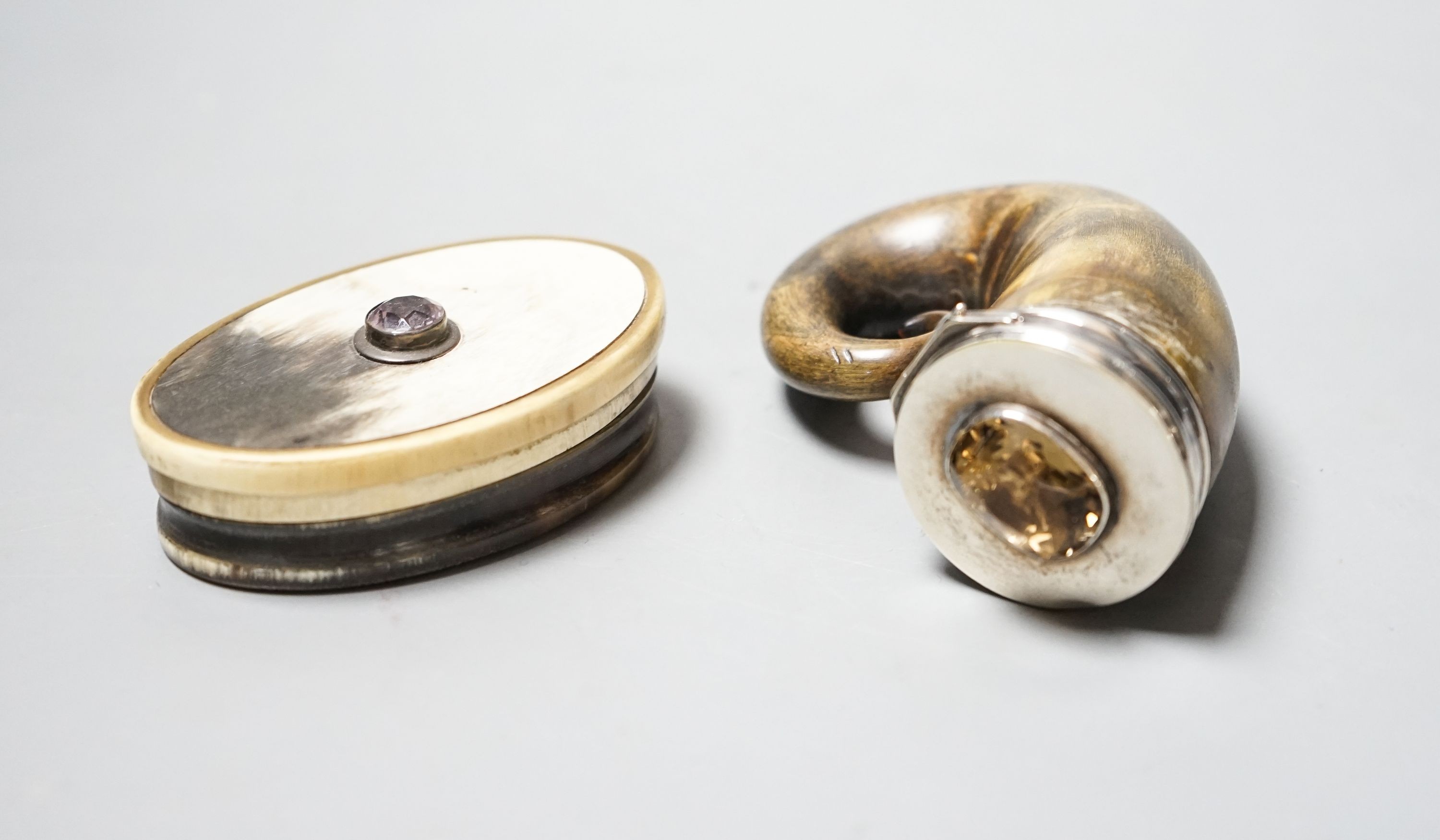 A 19t century white metal and gem set mounted horn snuff mull(a.f.)78mm and a similar oval horn snuff box.